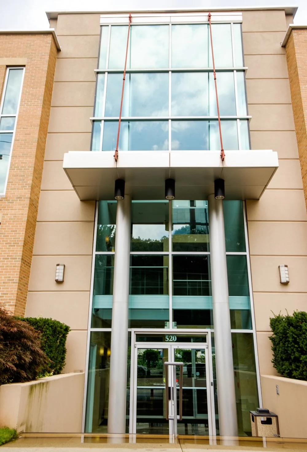 Modern medical building exterior in Fort Lee, NJ with brick and stone façade, large windows, and entrance numbered 520